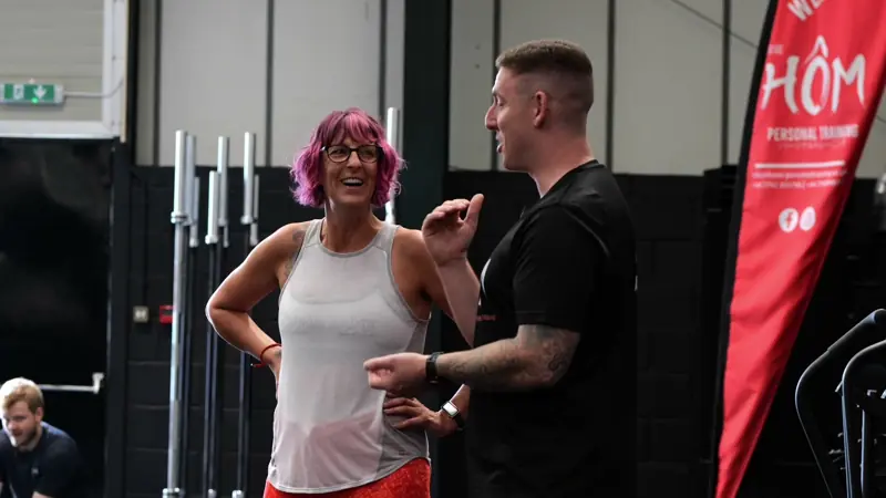A Hōm coach sharing a laugh with a member